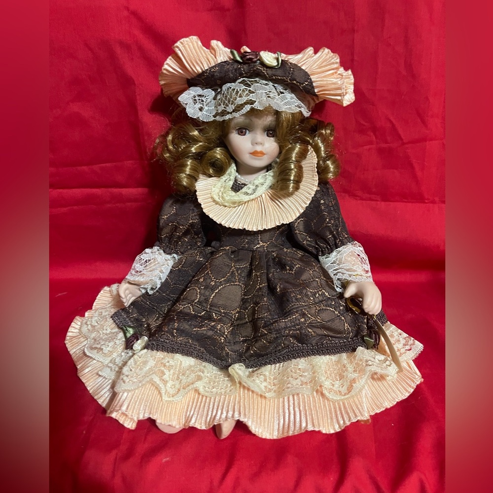 Ashley Belle collectible sitting porcelain doll. Approximately 8”